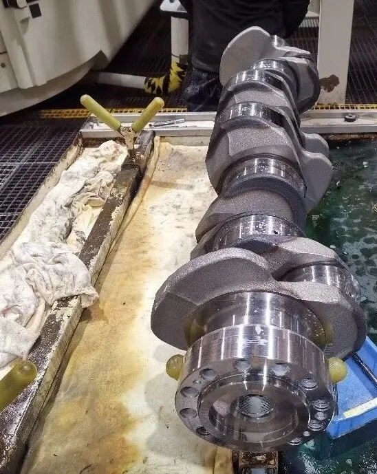 Crankshaft oil hole being drilled with solid carbide coolant-through drill in CNC machining centre — automotive production line
